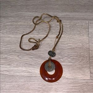 Amulet necklace with cash coin on leather rope